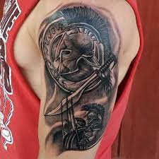 Black and grey ink spartan tattoo on man rib side. 90 Legendary Spartan Tattoo Ideas Discover The Meaning