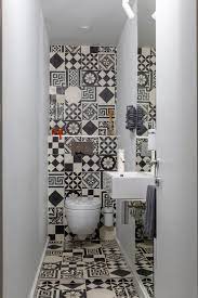White is always reliable to evoke clean and roomy space. The Small Powder Room Features Graphic Ceramic Tile From Couleurs Matures Patchwork A Pari Small Bathroom Wallpaper Bathroom Design Small Powder Room Small