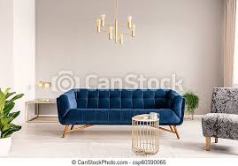 Do grey and cognac go together? Gold Lamp Hanging Above Royal Blue Sofa In Real Photo Of Light Grey Sitting Room Interior With Empty Wall Canstock