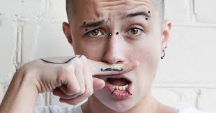 Tattoo Parlor Offers to Cover Up Hate Symbols and Finger Mustaches for Free