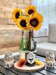 Right now ours has tea light candles in it. Diy Tutorial Sunflower Wine Bottle Centerpiece Craft And Sparkle