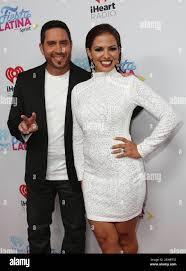 MIAMI, FL - NOVEMBER 07: TVradio personalities John Musa (L) and Jenny  Castillo (R) attend iHeartRadio Fiesta Latina presented by Sprint at  American Airlines Arena on November 7, 2015 in Miami, Florida.( ((