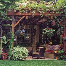 Gardeners often repurpose vintage items like ladders, tables, chairs, and rusted parts. It Looks Like A Cross Between English Garden And Tropical Escape Backyard Patio Backyard Patio