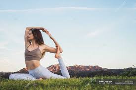 From herbal medicine treatments, to therapeutic yoga and bodywork, to intuitive tarot readings and life guidance, sara rose will hold space for your inner healer to emerge. Woman Stretching And Doing Yoga In Nature Practice Blue Sky Stock Photo 204210934