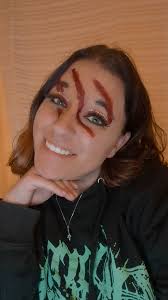 Ogre of Skinny Puppy plays with kitten at convention