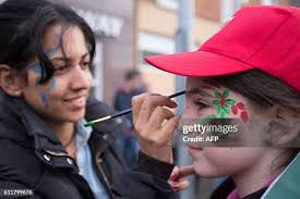 Daniela Galindo paints the face of Heather Joyce in the Mayo colours...  News Photo