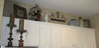 Stupendous Ideas For Space Above Cabinets With Wrought Iron Wine Bottle Rack Also Cathedral Kitchen Ca Cabinet Decor Above Cabinet Decor Kitchen Cabinets Decor