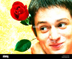Silly Photo of Young Man With Red Rose Mocking Exaggeration Stock Photo