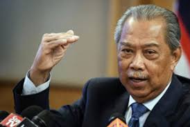 Malaysia's prime minister muhyiddin yassin waves as he arives at the national palace. Malaysia Gets New Prime Minister Backed By Old Regime Investvine