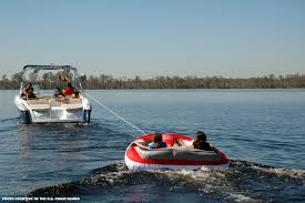 Image result for tubing behind boat