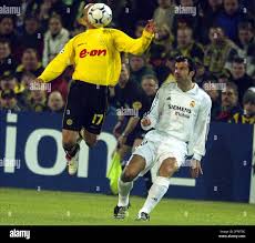 Madrid's Luis Figo, right, of Portugal, looks as Dortmund's Dede of Brazil  heads the ball during the Champions League second Phase group C match  between Borussia Dortmund and Real Madrid at the