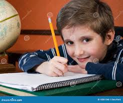 Smiling boy doing homework stock photo. Image of child