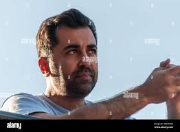 First Minister Humza Yousaf, with head teacher Nicky Murray (right),  addresses the school assembly during a visit to Claypotts Castle Primary  School in Dundee to launch the next chapter of the Reading