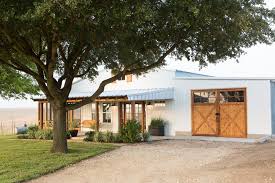 Modern farmhouse garage plan adkins. White Farmhouse Exterior And Garage With Brown Barn Style Garage Doors Hgtv