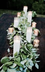 Beautiful Simple Eucalyptus Garland Used As A Table Runner With Simple White Candles S Rehearsal Dinner Decorations Wedding Centerpieces Wedding Decorations