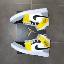 The upcoming release adds to the colorway's lineage as the pair comes in a light smoke grey and black upper. Custom Grey Yellow Nike Jordan 1s Black Swoosh The Custom Movement