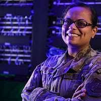Spc. Sarah Dubois sits at her desk where she reviews