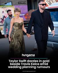 Taylor Swift dazzled in gold as she stepped out with Travis Kelce during a  stylish New York City outing, adding fresh buzz to ongoing wedding planning  rumours. The couple were seen hand