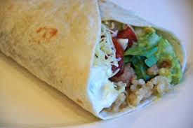 Layers of taco meat, queso, tostada, lettuce, tomato, salsa, hot sauce, and sour cream. Family Food Finds 7 Layer Burrito Vegan Fast Food Food Cooking Inspiration