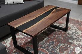 Coffee table in olive wood and transparent epoxy resin glossy finished. Resin River Coffee Table Bernzomatic