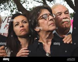 Suzanne Vitadamo, Terri Schiavo's sister, second from right, and her  husband Michael Vitadamo, meet with Gabriel Keys, left, and his sister  Josie, outside the Woodside Hopsice Thrusday afternoon march 24, 2005 in