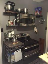The microwave has an exhaust hood underneath it for the purpose of hanging it above a stove. How Do I Hang An Ots Microwave Without A Cabinet Above Home Improvement Stack Exchange