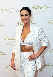 Busty Kirsty Gallacher, 47, shows off washboard abs in white crop top and  trousers at VIP party | The Sun
