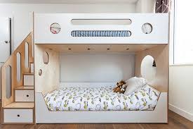 a simple bunk bed with storage stairs it s tried and true because it works custom cutouts keep this classic p kids bunk beds bunk beds bunk beds with storage