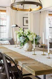 Extended arms bent at complementary angles support clear glass shades styled like wine glasses. The Living Dining Room Cottage House Flip Reveal
