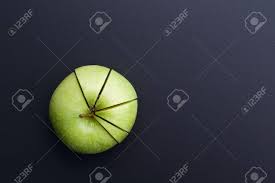 Green Apple Cutting In The Shape Of Pie Chart On Back Board