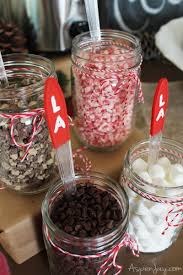 A hot cocoa bar with red plaid. Hot Chocolate Bar For Caroling Party Aspen Jay