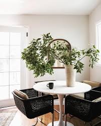 Beautiful Dining Nook With Black Woven Rattan Cantilever Chairs Simple Organic Touches And A White Tulip Dining Table Black Dining Room Beautiful Dining Rooms