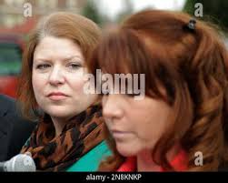 Kari Bales, left, listens as her sister, Stephanie Tandberg, right, reads a  statement to reporters Tuesday, Nov. 13, 2012, outside the building housing  a military courtroom