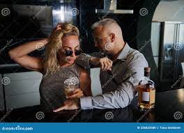 Charming Mature Man Seduces a Young Woman Sitting at a Bar Counter and  Drinking an Alcoholic Cocktail. Seduction, Flirt, Stock Photo - Image of  alcoholic, family: 236832580