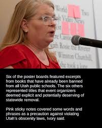 Standing before poster boards filled with text snippets of sexual scenes,  Layton faith leader Chuck Beickel called