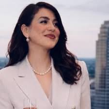 Jerry Pascal owner of Pierre Davon Pascal Clothing and graduate of Spring  GR's most recent class of entrepreneurs interacting with potential  customers at his table at the Money Matters: Financially Empowering the