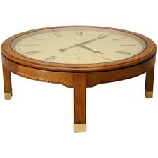 A white face with black roman numerals and hands, a glass top with brass capped feet. Antiques On Old Plank Road Vintage American Oak Clock Coffee Table By Howard Miller Coffee Table Table Clock Table