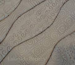 Create a design or pattern on your slab with smaller pieces of clay. Slab Clay House Project