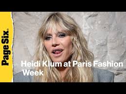 Heidi Klum pairs completely see-through lace dress with a platinum grill at  Vetements show during...