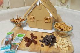 This classic gingerbread house is decorated with a cute pink tree in the yard and bright sprigs of holly above the door. Delicious Candy Alternatives To Decorate Your Gingerbread House