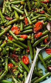 Green Beans With Tomatoes And Olives For A Mediterranean Twist On Simple Green Beans We Add Tomatoes Green Beans Mediterranean Cookbook Vegetable Side Dishes