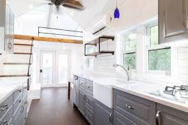 The tiny house was designed by n55 and is equipped with solar panels and micro windmills and it inside you can find beautiful wood furnishings, aged oak flooring and vintage copper features. 28 Foot Tiny House With 408 Sq Ft Inside