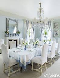 Pale blue plate setting on table with gold candle holder in dining room interior. Blue And White Elegant Dining Room The Glam Pad