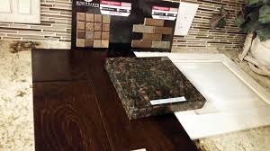 Kitchen Dark Wood Floor Cream Distressed Cabinets Dark Granite Copper Accent Tiles On Travertine Backspl Dark Wood Floors Travertine Backsplash Accent Tile