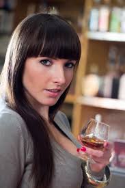 Young Woman Holding Glass Of Brandy Stock Photo