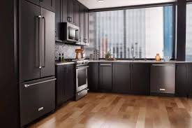 The pastel blue used on the lower cabinets of this kitchen compliment the other other pastel colors used on the floor and works with the light wood. Ge Black Slate Appliances Cabinet Stone
