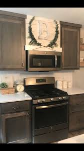 Like many other kitchen designs, farmhouse kitchens use many natural materials like wood cabinets, hardwood. Shiplap Hood Vent Modern Farmhouse Laurel Wreath Gray Cabinets Home Decor Kitchen Home Kitchens Kitchen Remodel