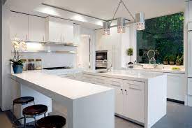 A clean white countertop and glossy brown cabinetry, paired with simple brown backed barstools give a modern feel to this kitchen. Kitchen Peninsula Ideas 34 Gorgeous And Functional Kitchen Peninsula Ideas