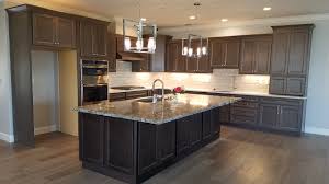 Many are tempted to match grey cabinetry with a grey or white countertop, but black is a bold choice that certainly pays off. Auburn Custom Kitchens Gallery