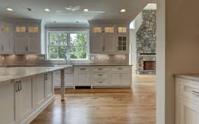 Kitchen Open To Great Room With Stone Fireplace Quartz Tops Custom White Kitchen With Inset Doors And Glass U Under Cabinet Lighting Kitchen Cabinet Lighting